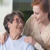 Aid comforting woman